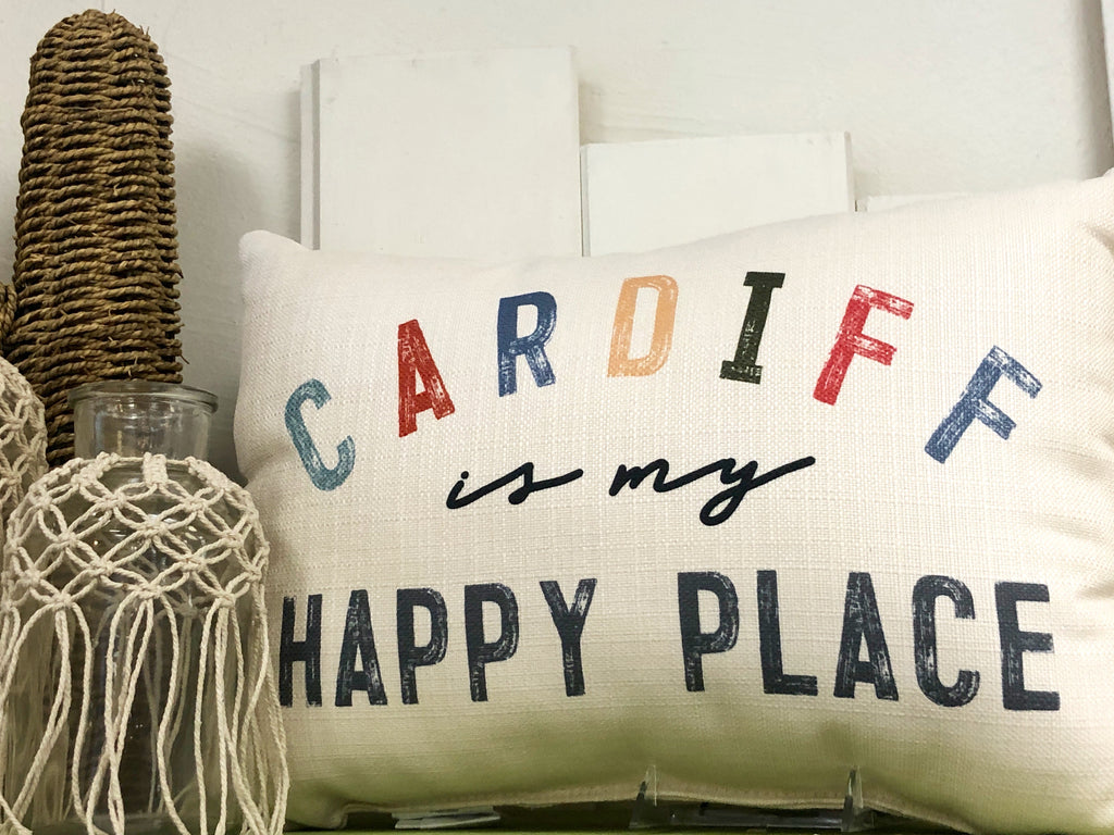 Cream pillow with words "Cardiff is my happy place"